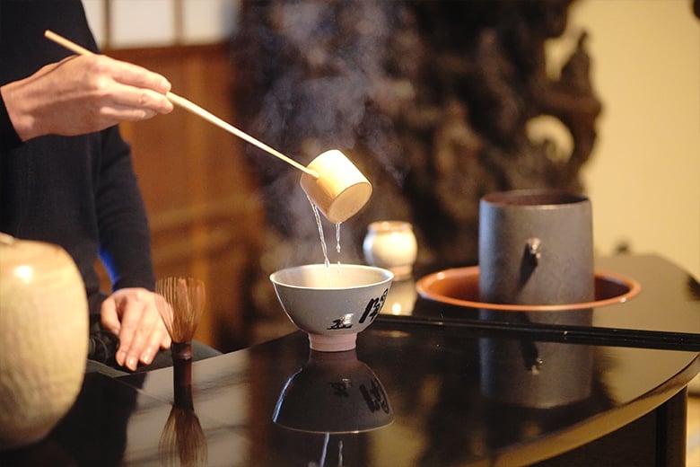 A Priest Guides the Way in Kanshinji's Kondo Hall for Meditation